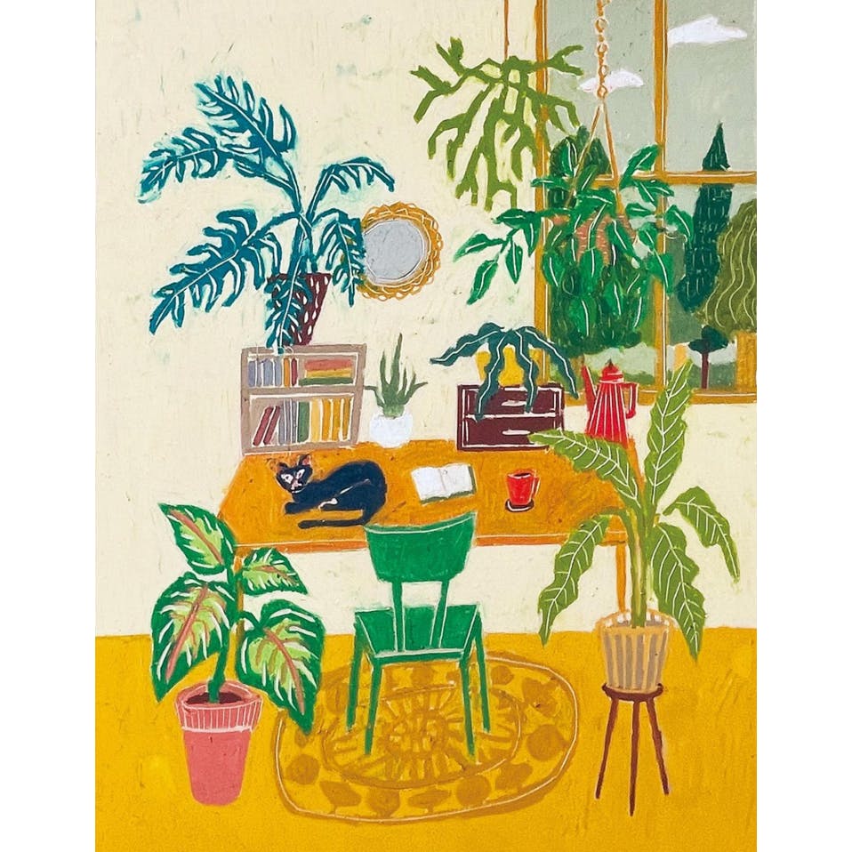 植物と黒猫のいる机